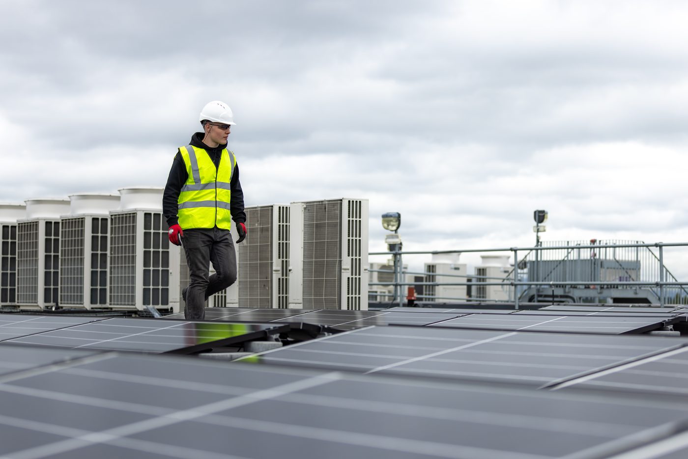 Monteur auf einer Aufdach-Photovoltaikanlage